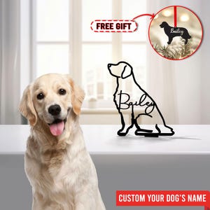 May include: A golden retriever dog sits in front of a custom dog silhouette ornament. The ornament is black metal and features the name "Bailey". The ornament is a free gift with purchase.