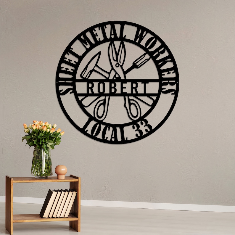 May include: Black metal sign with the words "Sheet Metal Workers" and "Local 33" around a circle. The name "Robert" is in the center of the circle, with a hammer, screwdriver, and scissors inside the circle.