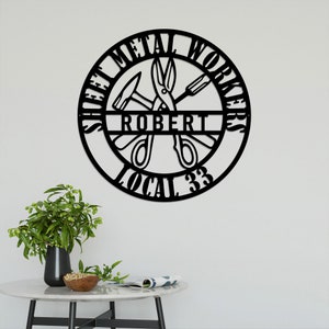 May include: Black metal sign with the words "Sheet Metal Workers" and "Local 33" around a circle. Inside the circle are a hammer, pliers, and a screwdriver. The name "Robert" is written in a banner across the center.