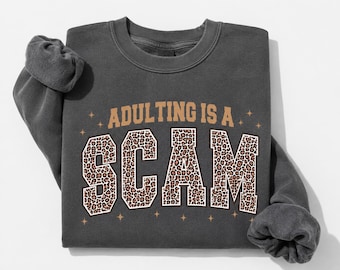 Adulting Is A Scam Sweatshirt | Comfort Colors Pepper Crewneck | Funny Leopard Print Graphic Sweatshirt | Trendy Cozy Pullover Gift for Her