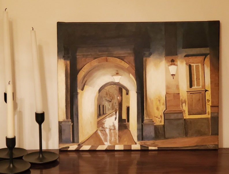 May include: A painting of a narrow, arched alleyway with a street lamp and a person walking in the distance. The alleyway is lit by a soft, warm light, and the walls are painted in shades of yellow and brown.