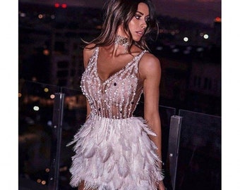 white sequin dress with feathers