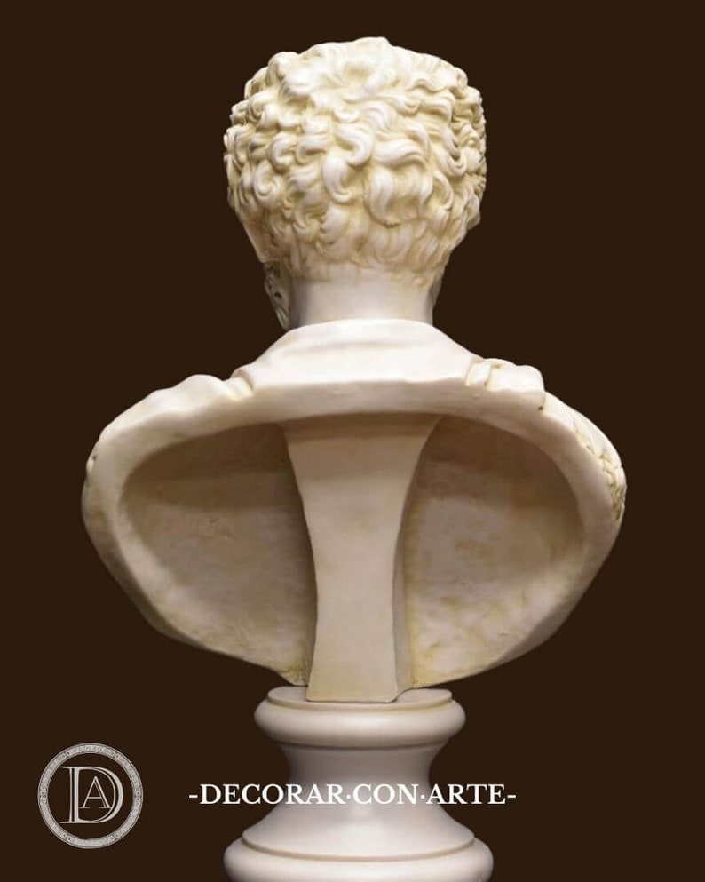 May include: A white plaster bust of a person with curly hair. The bust is on a white pedestal. The bust is facing away from the camera.