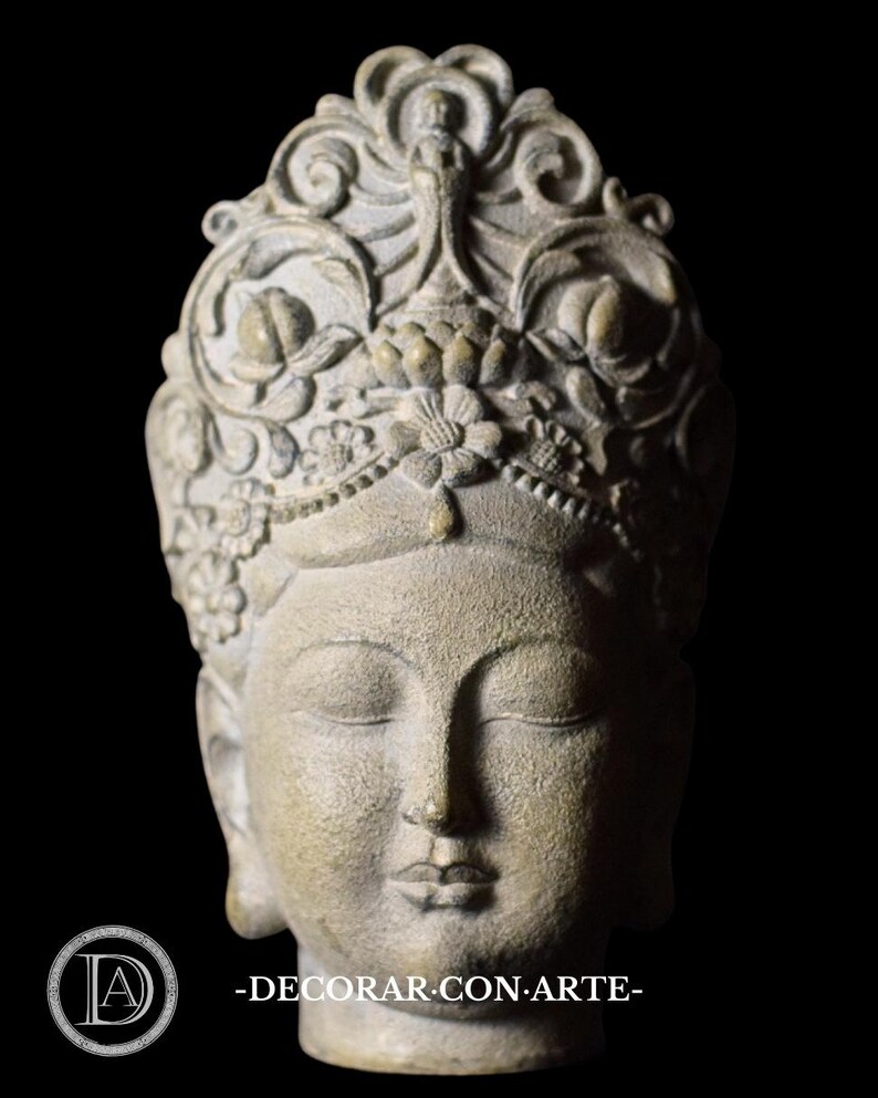 May include: A gray stone sculpture of a woman's head with a detailed crown of flowers and leaves. The woman's eyes are closed and her expression is serene.