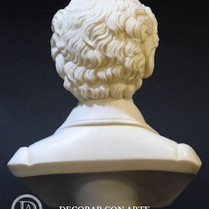 Puede incluir: Busto de yeso blanco de una persona con el pelo corto y ondulado. El busto se ve desde atr&aacute;s, mostrando la parte posterior del cuello y los hombros. El busto est&aacute; sobre una base negra.
