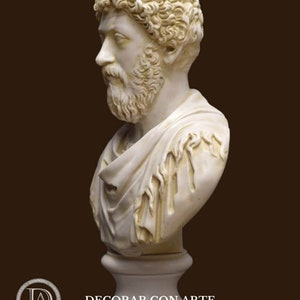 May include: A white plaster bust sculpture of a man with curly hair and a beard. The bust is on a white pedestal.