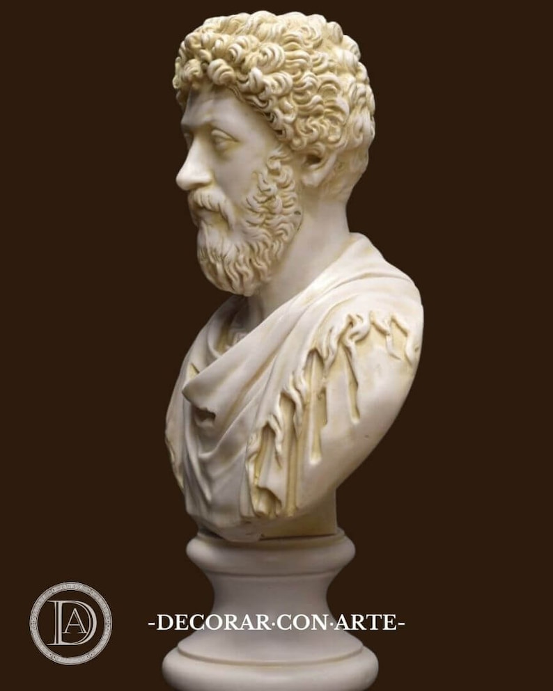 May include: A white plaster bust sculpture of a man with curly hair and a beard. The bust is on a white pedestal.
