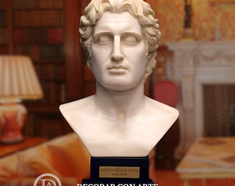 May include: A white marble bust of Alexander the Great, with detailed facial features and curly hair. The bust is mounted on a dark blue base with a gold plaque that reads "Alexander the Great" and the dates 356-323 BC. The bust is a classical sculpture.