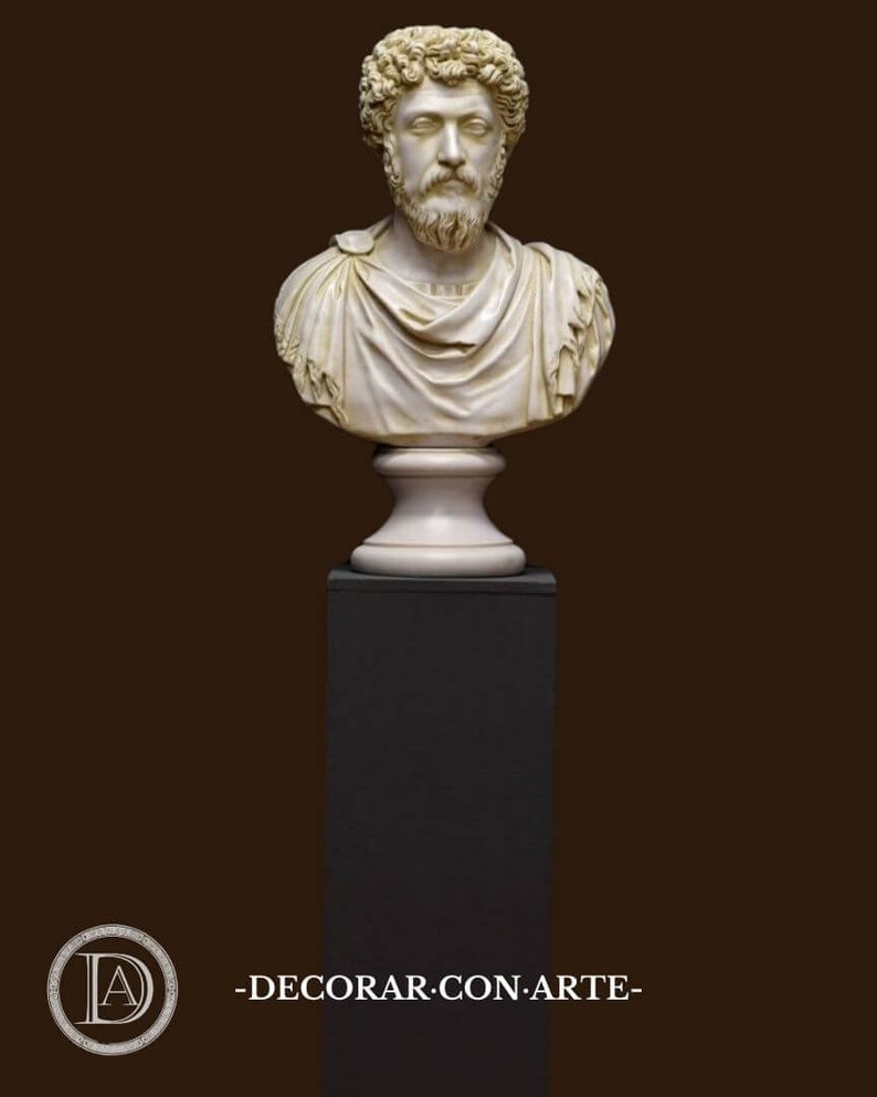 May include: A white marble bust of a man with a beard and curly hair, on a black pedestal. The bust is on a white base with a decorative design. The bust is a replica of a Roman emperor.