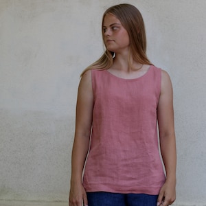 May include: A sleeveless, salmon-colored linen top with a scoop neck.