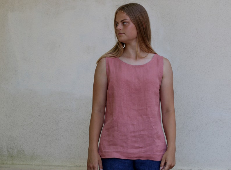 May include: A sleeveless, salmon-colored linen top with a scoop neck.