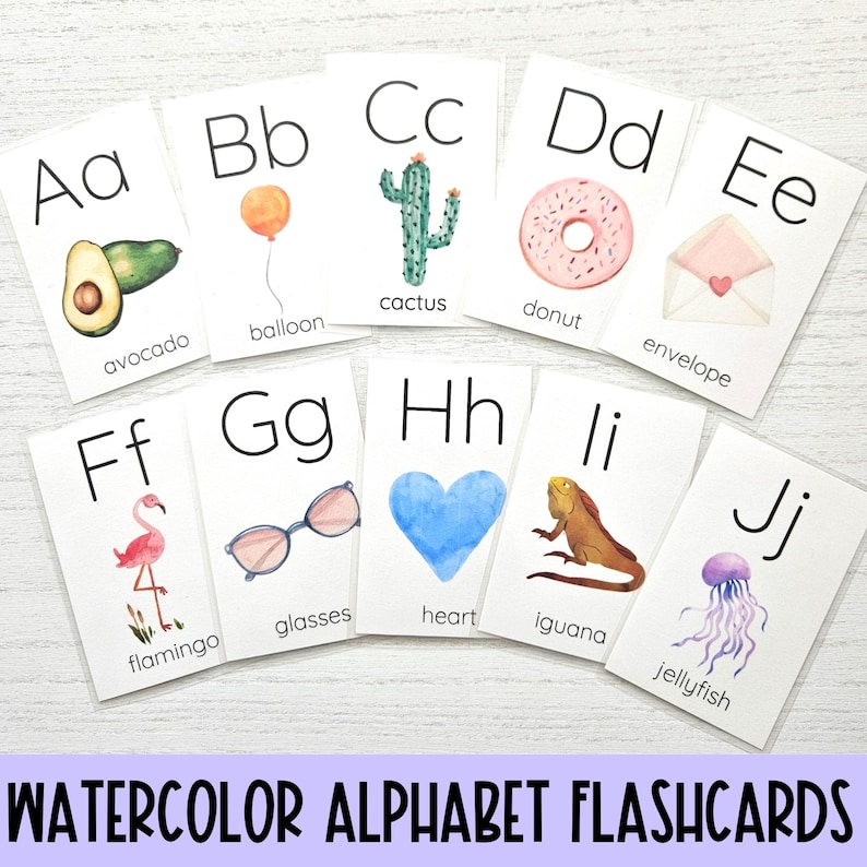 May include: Watercolor alphabet flashcards with illustrations of an avocado, balloon, cactus, donut, envelope, flamingo, glasses, heart, iguana, and jellyfish. Each card features a letter of the alphabet and the corresponding word.