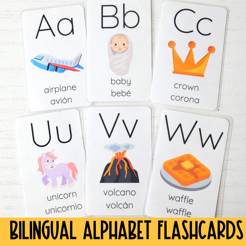 May include: Bilingual alphabet flashcards with illustrations and English and Spanish words. The letters are A, B, C, U, V, and W. The illustrations include an airplane, baby, crown, unicorn, volcano, and waffle.
