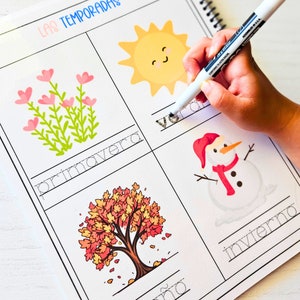 May include: A spiral-bound educational worksheet titled LAS TEMPORADAS featuring four quadrants with illustrations of a sun, flowers, a tree, and a snowman, each with corresponding Spanish text to trace using a white dry-erase marker.