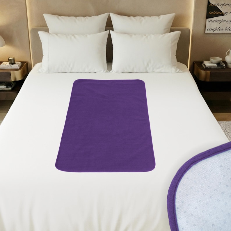 Grey GRIPME waterproof polar fleece blanket 100x70cm folded showing compact size, non-slip silicone grip dots, travel-friendly bed protector for intimacy and incontinence