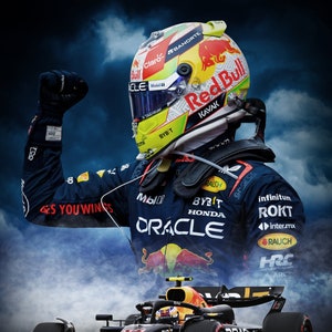 May include: A Formula 1 race car driver wearing a yellow, green, and red racing helmet with the text "Red Bull" and "KAVAK" on it. The driver is raising his right arm in victory. The car is black and yellow with the text "Oracle" on the side. The car is surrounded by smoke.