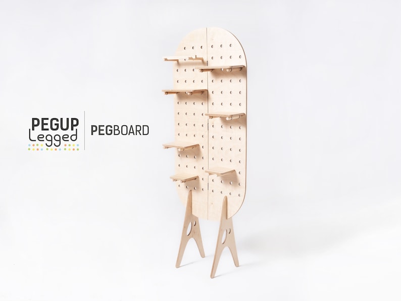 May include: A freestanding pegboard with five shelves and a rounded top. The pegboard is made of light wood and has a grid of holes for hanging items. The pegboard is supported by two A-shaped legs.