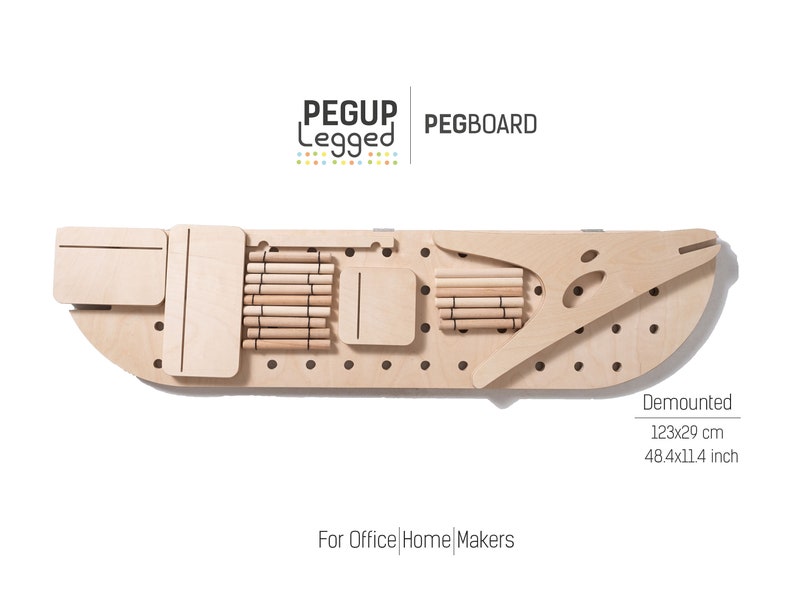 May include: A wooden pegboard with a curved shape and a set of wooden pegs. The pegboard is labelled "PEGUP Legged PEGBOARD" and "For Office | Home | Makers". The pegboard is 123 cm by 29 cm.