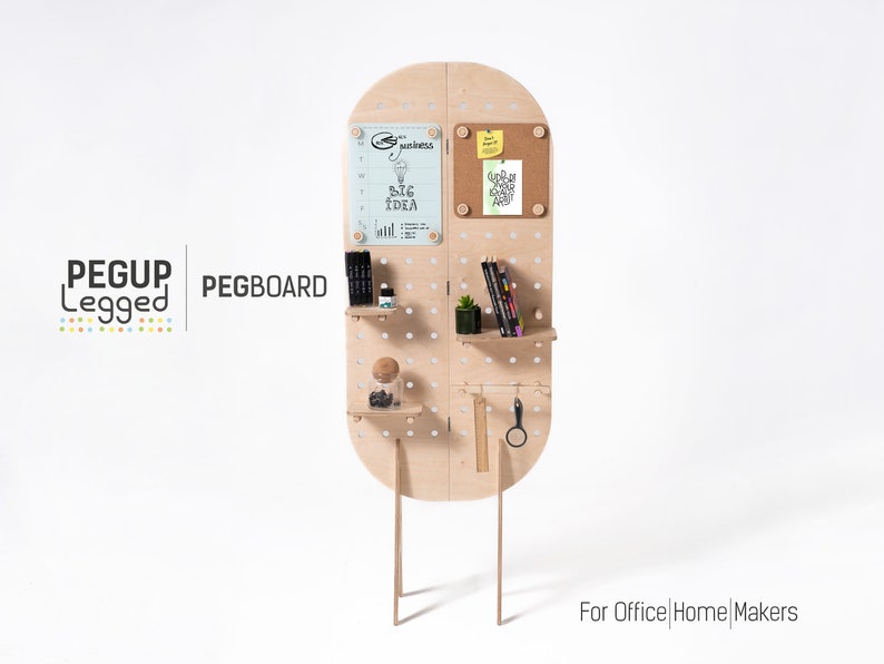 May include: A freestanding pegboard with shelves and a corkboard. The pegboard is made of light wood and has a rounded top. It has a variety of items on it, including pens, pencils, a plant, and a small glass jar. The pegboard is labelled "PEGBOARD" and "PEGUP Legged". The text "For Office | Home | Makers" is at the bottom of the image.