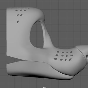 May include: A 3D model of a furry muzzle with a textured nose and holes around the mouth and eyes.