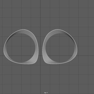May include: Two white, rounded, hollow forms, resembling a pair of eyes, are positioned side-by-side against a grey background.