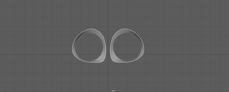 May include: Two white, rounded, hollow forms, resembling a pair of eyes, are positioned side-by-side against a grey background.