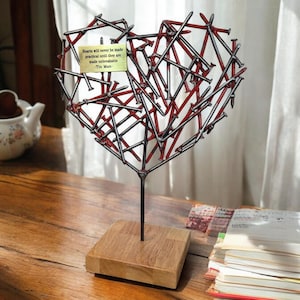 Brutalist Heart Sculpture: Handmade Steel Nail Art with Red Accents