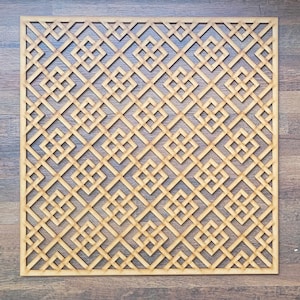 May include: A wooden geometric wall panel featuring a repeating pattern of squares and diamonds. The panel is crafted from light brown wood and has a natural finish.