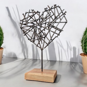 Brutalist Heart Sculpture: Handcrafted Steel Nail Art with Patina