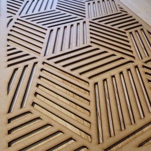 May include: A wooden wall decor panel featuring a geometric pattern of intersecting lines, creating a honeycomb-like design. The panel is made from light brown wood and has a natural finish.