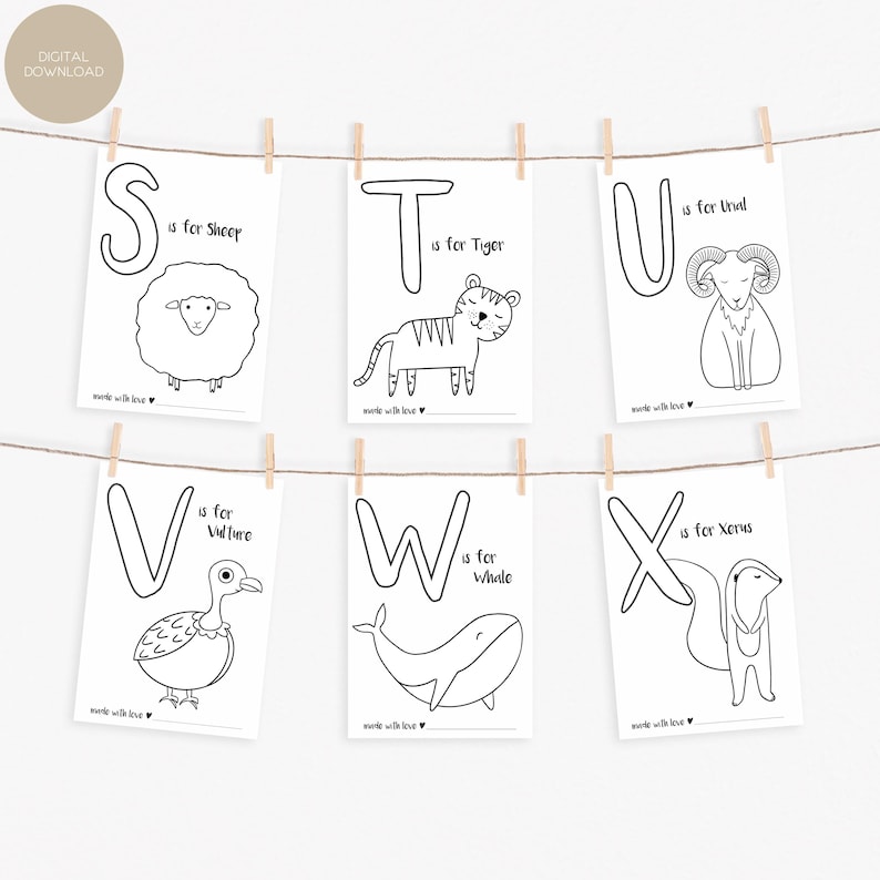 May include: A set of six black and white alphabet art prints, each featuring a letter and an animal illustration. The prints are suspended from a string with wooden clothespins. The letters are S, T, U, V, W, and X, with corresponding animals like a sheep, tiger, and whale.