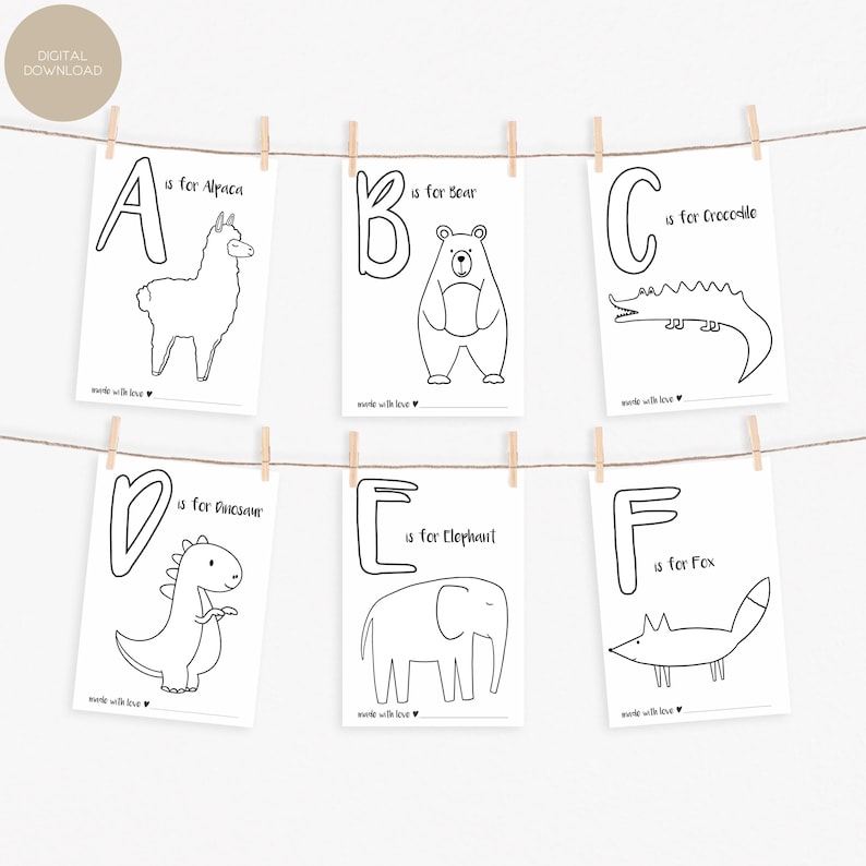 May include: Six black and white alphabet flashcards are displayed, each featuring a letter and an animal illustration. The cards are suspended from a string with wooden clothespins. The letters A through F are shown, with animals like an alpaca, bear, crocodile, dinosaur, elephant, and fox.