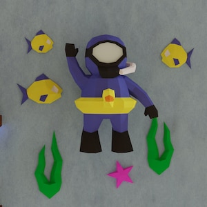 Puede incluir: Un buzo de papel azul con un cinturón amarillo y una máscara facial blanca. El buzo está rodeado de algas verdes, peces amarillos y una estrella de mar rosa.