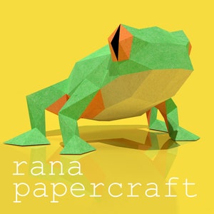 May include: Green and orange papercraft frog with the text "rana papercraft" below it.