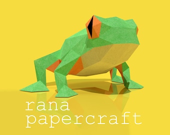 May include: Green and orange papercraft frog with the text "rana papercraft" below it.
