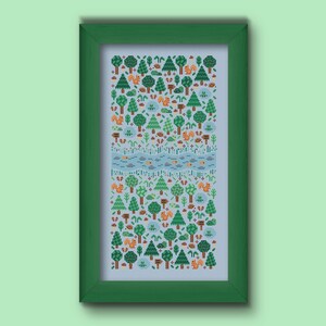Folk cross stitch chart consisting in different types of trees and forest animals (squirrels, frogs, hedgehogs) arranged on a rectangle shape with a river crossing in the middle. The colors are natural, mainly green, blue and brown with a touch of red and orange. Stitched on sky blue Aida.