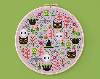 May include: A purple and white cross-stitch pattern with a variety of Halloween-themed images, including black cats, skulls, cauldrons, and bats.