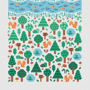 Close up detail of the Forest Garden. Showing trees, plants, hedgehogs, mushrooms, frogs, fish and squirrels. Embroidered on white Aida, this is a modern and cute design, great for nursery decor.