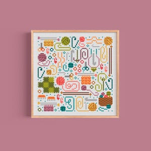May include: A colorful cross-stitch pattern featuring various knitting and crocheting supplies, including yarn balls, needles, hooks, and scissors. The pattern is framed in a light wood frame.