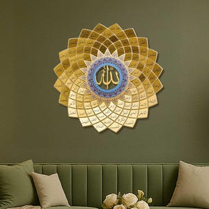 May include: A gold and blue Islamic wall art with the word 'Allah' in the center, surrounded by a floral design. The art is hanging on a green wall above a green sofa with white throw pillows and a bouquet of white flowers on a coffee table.
