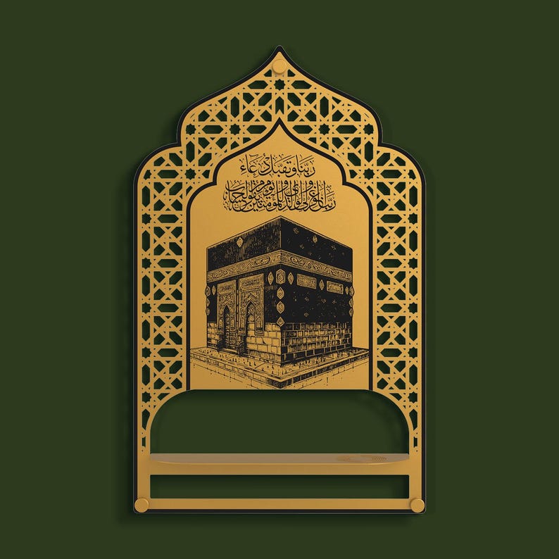 May include: A gold-colored wall-mounted shelf featuring an arched frame with intricate geometric lattice patterns. The central panel displays a black illustration of the Kaaba with Arabic calligraphy above it, set against a dark green background.