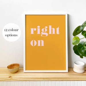 May include: A white framed print with a yellow background and the words "right on" in pink lettering.