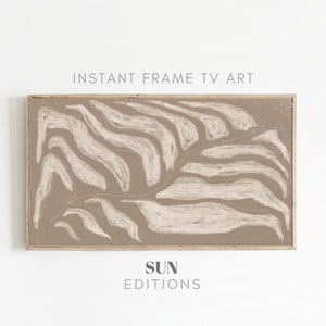 May include: Abstract art print with a beige background and white abstract shapes. The print is framed in a light wood frame. The text "SUN EDITIONS" is printed below the image.