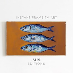 May include: A painting of three blue fish on a yellow background. The fish are arranged in a row, with the largest fish at the top and the smallest fish at the bottom. The painting is framed in a light wood frame.
