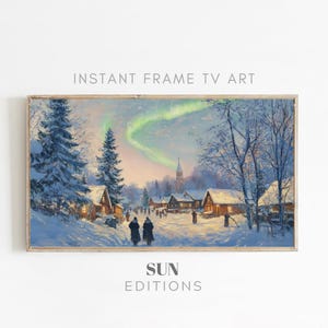 May include: A painting of a snowy village scene with a green aurora borealis in the sky. The village is lit up with warm lights and there are people walking around. The painting is framed in a light wood frame.