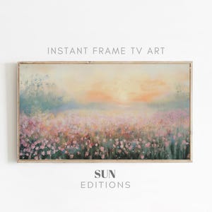 May include: A framed painting depicting a field of pink flowers with a hazy sunset in the background. The painting is in a light wood frame and features the text "SUN EDITIONS" below it.