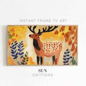 Może przedstawiać: Namalowany obraz w ramie przedstawiający stylizowanego jelenia z dużymi rogami stojącego w lesie. Jeleń jest namalowany w odcieniach różowego, czerwonego i czarnego, na białym tle. Las jest namalowany w odcieniach żółtego, pomarańczowego i niebieskiego.