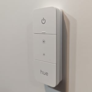 Invisible holder for the Philips Hue Dimmer Switch v2. Magnetic holder for the dimmer, fastened using NanoTape. image 1