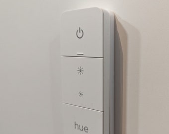 Invisible holder for the Philips Hue Dimmer Switch v2. Magnetic holder for the dimmer, fastened using NanoTape.