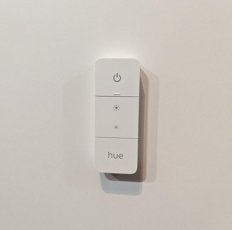 Invisible holder for the Philips Hue Dimmer Switch v2. Magnetic holder for the dimmer, fastened using NanoTape. image 2